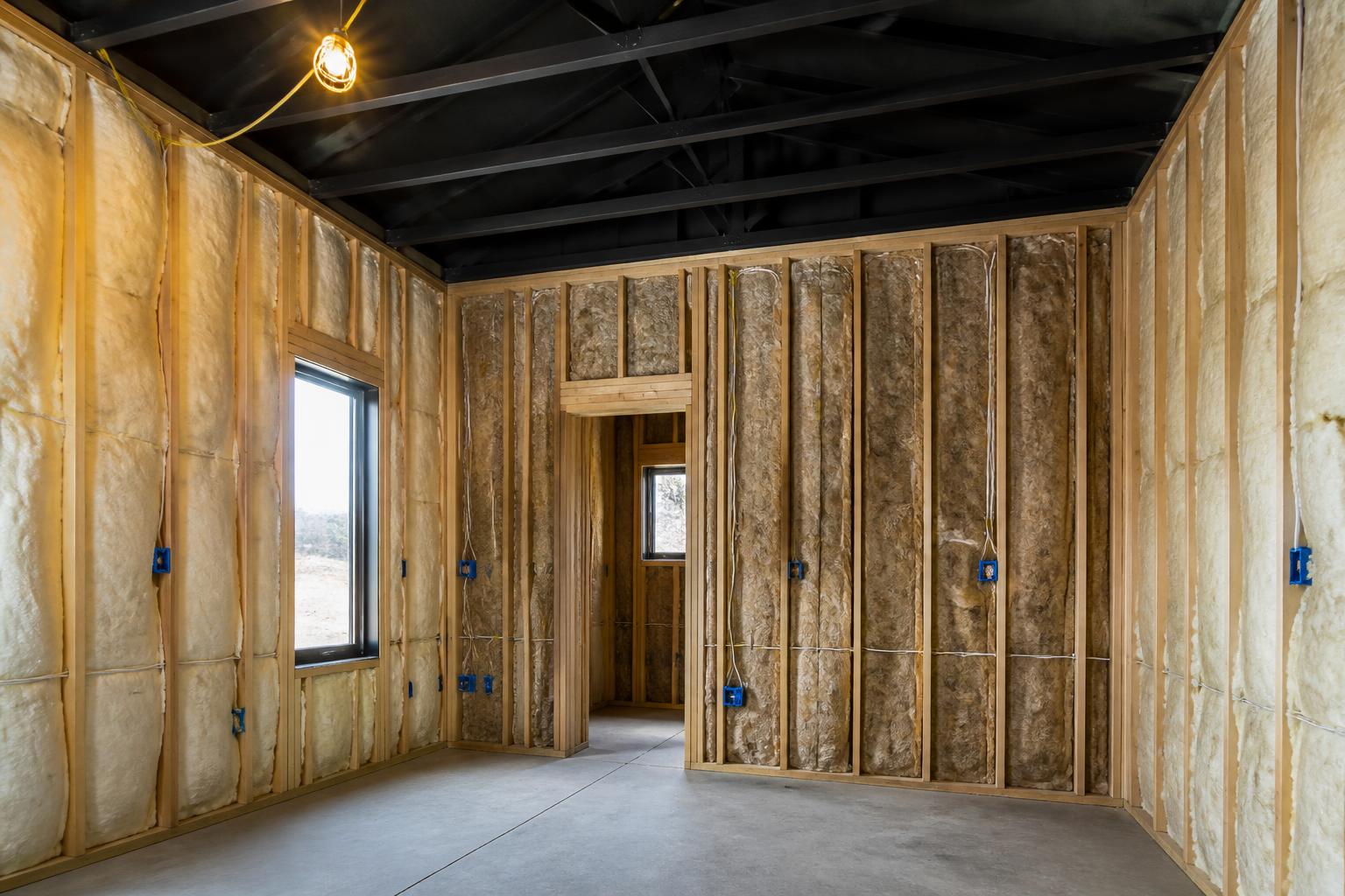 Interior rough-in with insulation, electrical and black-painted ceiling structure